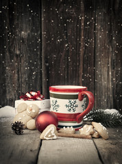 Mulled wine and Christmas decorations on vintage wooden table