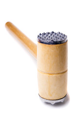 Close up view of a meat hammer isolated on a white background.
