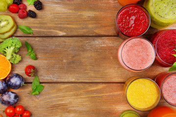 Glasses of tasty fresh juice, on wooden table.