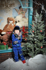 Christmas boy around Christmas tree with gifts