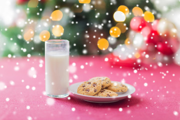 close up of cookies and milk glass on table
