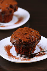Yummy chocolate cupcake on table