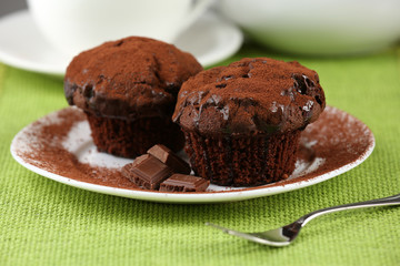 Yummy chocolate cupcake on table