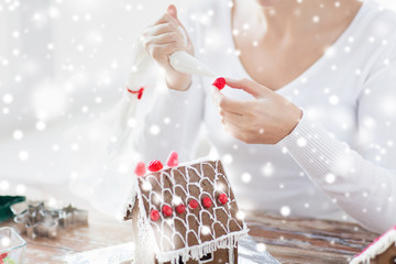 close up of woman making gingerbread houses