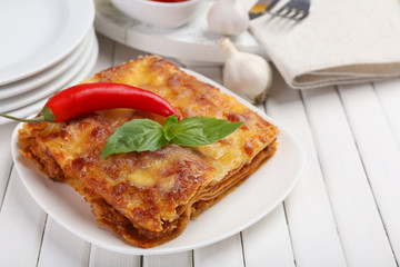 Portion of tasty lasagna on table