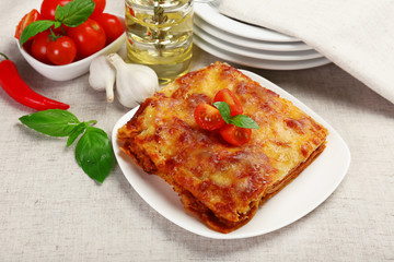 Portion of tasty lasagna on table