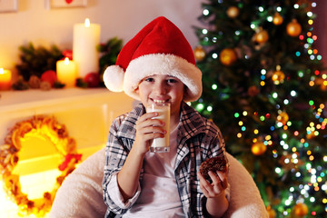 Little boy sitting near fireplace in room