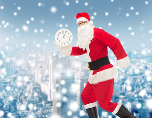 man in costume of santa claus with clock