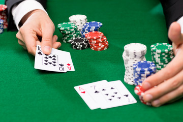 poker player with cards and chips at casino