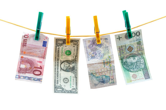 Different currency banknotes hanging on clothesline
