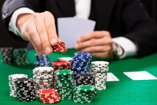 poker player with cards and chips at casino