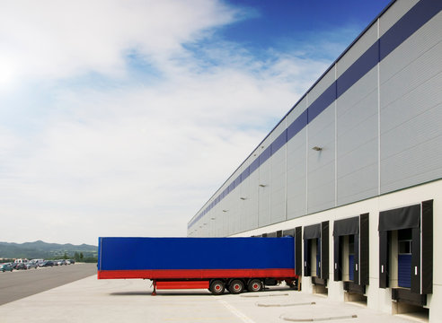 Blue trailer on the storage delivering goods