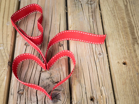 ribbon hearts against grungy wooden background