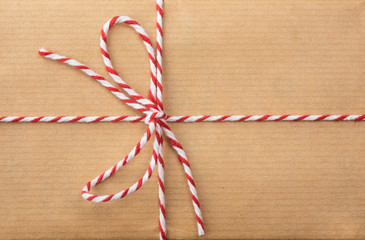 string bow against brown paper