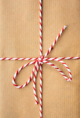 string bow against brown paper