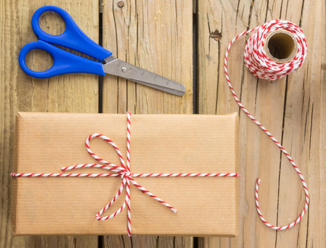 string and brown paper parcel with scissors and string