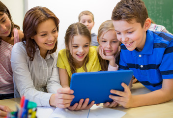 group of kids with teacher and tablet pc at school