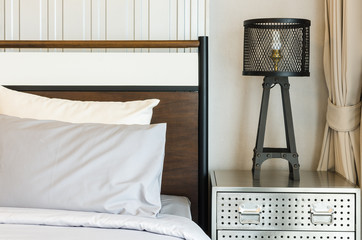 pillows on bed with modern lamp