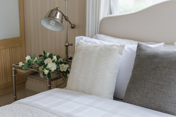 bed and white pillows with lamp