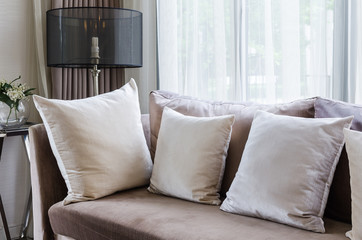 modern interior pillows on brown sofa