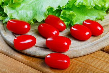 Small tomatoes and salad leaves close up