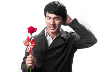 Asian handsome man hold the red rose with love