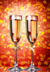 Glasses of champagne on bright background