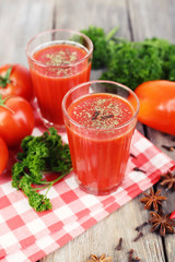 Tomato juice in glasses and fresh vegetables