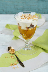 Tasty dessert with oat flakes and honey, on table