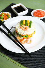 Boiled rice with shrimps and vegetables on bamboo mat