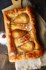 Tasty homemade pear pie on wooden table