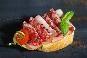 Tasty sandwich on wooden table, close up