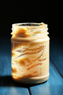 Empty Peanut Butter Jar On Table, On Dark Background