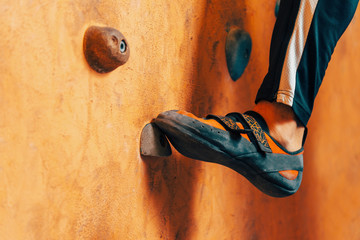Male foot on climbing wall