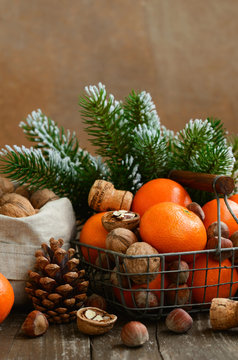 Xmas decoration with tangerines and nuts with copyspace on woode