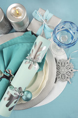 Christmas table place settings in aqua blue, silver and white 