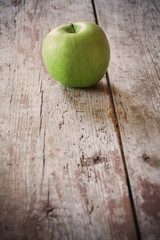 green apple on wooden background