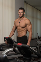 Obraz na płótnie Canvas Man Jogging In A Gym