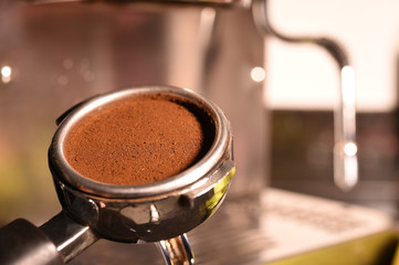 Freshly ground coffee beans in a metal filter.