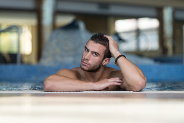 Male Swimmer Resting In Pool