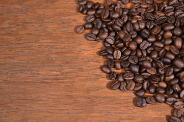 Coffee beans on wooden background.