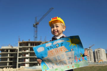 funny boy with a picture of the future house - 74521679