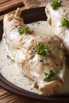 Dietary rabbit meat in cream sauce on the table. Vertical