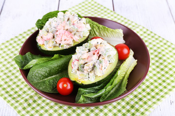 Tasty salad in avocado on plate table close-up