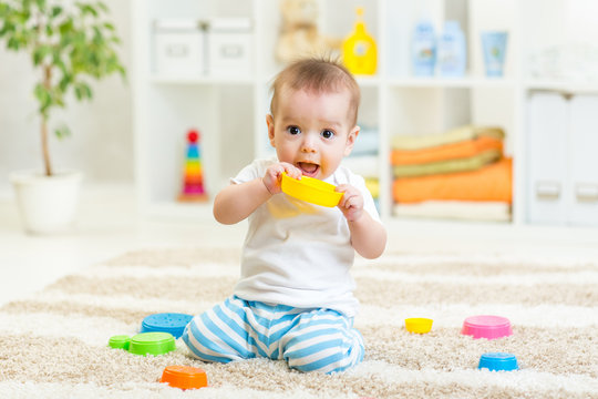 baby boy playing with toys indoor