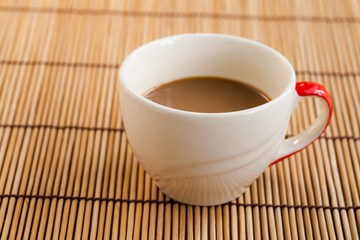 Cup of hot coffee on wooden table.
