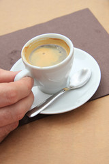 Man holding espresso cup