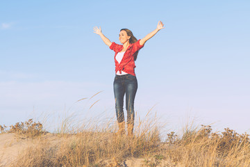 woman with hands up in the air