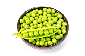 Green peas in brown bowl with pod