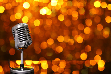 Silver microphone on orange background